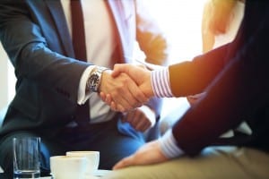 Business people shaking hands, finishing up a meeting.