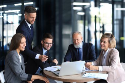 business team working in laptop check results to their work