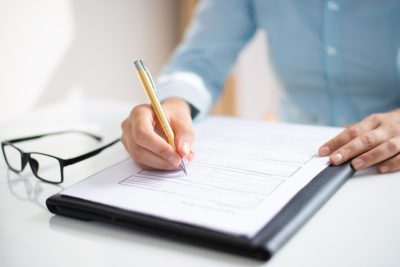 closeup business woman making notes document